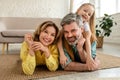 Cheerful Parents And Daughter Posing On Floor Hugging At Home Royalty Free Stock Photo