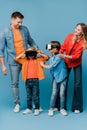 Cheerful parents with kids in virtual reality headsets Royalty Free Stock Photo