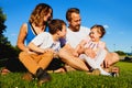 Cheerful parents sitting on grass with children Royalty Free Stock Photo