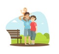 Cheerful Parents and Their Toddler Baby Walking in Park Outdoor, Boy Sitting on Shoulders of His Father, Happy Family