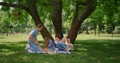 Cheerful parents tickling kids on picnic. Family amusement on summer weekend. Royalty Free Stock Photo