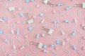Cheerful pattern. Stationery chaotically scattered on a pale pink background. Staples, asterisks and buttons are in Royalty Free Stock Photo