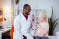 Cheerful pediatrician feeling good communicating with girl