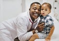 Cheerful pediatrician doing a medical checkup of a young boy