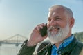 Cheerful pensioner having a phone talk stock photo Royalty Free Stock Photo