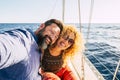 Cheerful people and happy caucasian couple enjoying the outdoor leisure acctivity during sea vacation taking a selfie picture