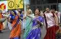 Cheerful people in Indian clothes, Hare Krishna believers, dancing, singing and playing drums on the street. Kyiv