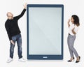 Cheerful people standing beside a tablet Royalty Free Stock Photo