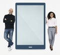 Cheerful people standing beside a tablet Royalty Free Stock Photo