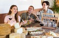 Cheerful people tasting artisanal goat cheese at Spanish farm