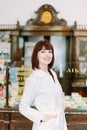 Cheerful pharmacist chemist woman standing in pharmacy drugstore Royalty Free Stock Photo