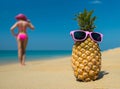 Cheerful pineapple glasses and a woman in a bikini sunbathing on the beach on sea backgrounde beach on sea background.