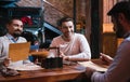 Cheerful pleasant men discussing the menu