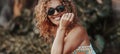 Cheerful portrait of pretty middle age young woman smiling at the camera in outdoor leisure activity with nature foliage Royalty Free Stock Photo