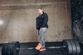 Cheerful positive obese girl standing next to the barbell