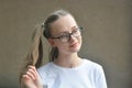 Cheerful positive pretty kid, teen age girl, being in great mood and showing her smile and long hair tails Royalty Free Stock Photo