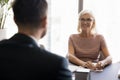 Cheerful positive senior employer woman talking to candidate man Royalty Free Stock Photo