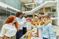 Team of young creative designers celebrate successful finish of job Royalty Free Stock Photo