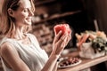 Cheerful positive woman holding red pepper