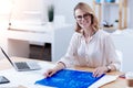 Cheerful positive woman working with a blueprint Royalty Free Stock Photo