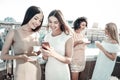 Cheerful positive women standing together