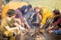 Cheerful positive young people learning to cook mushrooms