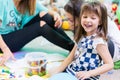 Cheerful pre-school girl wearing a trendy T-shirt while playing Royalty Free Stock Photo