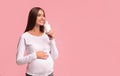 Cheerful Pregnant Lady Drinking Natural Milk Standing On Pink Background Royalty Free Stock Photo