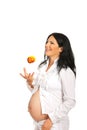 Cheerful pregnant throwing apple Royalty Free Stock Photo