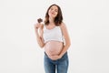 Cheerful pregnant woman eating chocolate. Eyes closed. Royalty Free Stock Photo