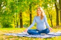 Cheerful pregnant woman sitting in the lotus positio Royalty Free Stock Photo