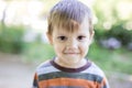 Cheerful preschool boy outdoors