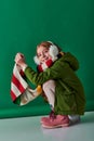 cheerful preteen girl in ear muffs