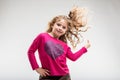 Cheerful preteen girl playing with her curly hair Royalty Free Stock Photo