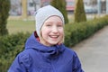 Cheerful preteen girl 9-11 year old laughing on a walk outdoors.