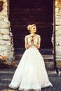 Cheerful girl or bride in white wedding dress with flower Royalty Free Stock Photo