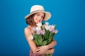 Cheerful pretty little girl in hat holding bouquet of flowers Royalty Free Stock Photo