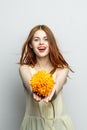 cheerful pretty woman with a big yellow flower in her hands emotions red lips fun charm Royalty Free Stock Photo