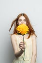 cheerful pretty woman with a big yellow flower in her hands emotions red lips fun charm Royalty Free Stock Photo