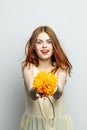 cheerful pretty woman with a big yellow flower in her hands emotions red lips fun charm Royalty Free Stock Photo