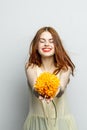 cheerful pretty woman with a big yellow flower in her hands emotions red lips fun charm Royalty Free Stock Photo