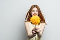 cheerful pretty woman with a big yellow flower in her hands emotions red lips fun charm Royalty Free Stock Photo