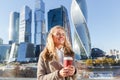 Cheerful pretty woman enjoying coffee and warm autumn sunny day Royalty Free Stock Photo