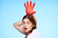 cheerful pretty woman holding an inflated rubber glove above her head cleaning Royalty Free Stock Photo