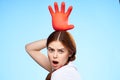 cheerful pretty woman holding an inflated rubber glove above her head cleaning Royalty Free Stock Photo