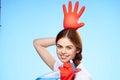 cheerful pretty woman holding an inflated rubber glove above her head cleaning Royalty Free Stock Photo