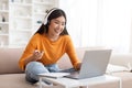 Cheerful pretty young asian woman working from home Royalty Free Stock Photo