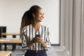 Cheerful pretty young Black business employee holding mobile phone Royalty Free Stock Photo