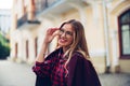 Cheerful pretty young lady holds his glasses her hands and smiles at his interlocutor. Royalty Free Stock Photo