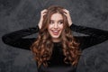 Cheerful pretty young woman touching her long curly beautiful hair